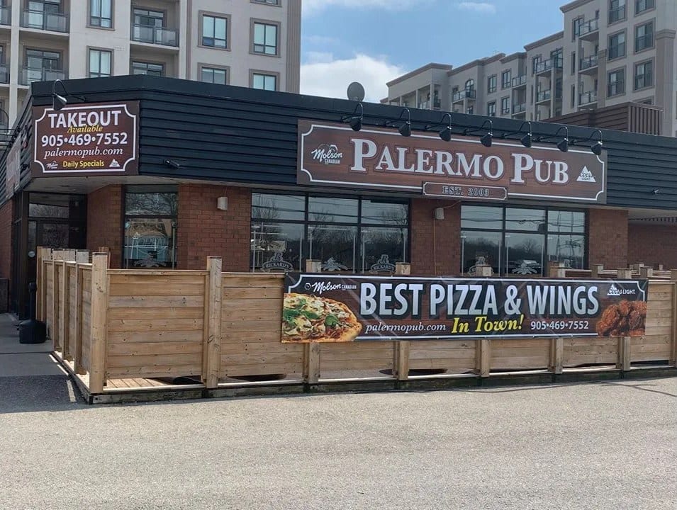 The Palermo Pub building on Old Bronte Road, with its wooden patio fence and takeout sign